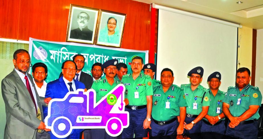 M Kamal Hossain, Managing Director of Southeast Bank Limited, handing over a cheque of fund to Md. Iqbal Bahar, Commissioner of Chittagong Metropolitan Police for purchase a wrecker for its Traffic Department at its office on Tuesday. Top officials from b
