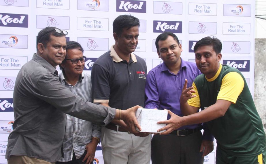 Senior member of BSJA Motaher Hossain Masum (left) handing over the Man of the Match award to a winner of the Kool-BSJA Media Cup Football Tournament at BFF Artificial Turf on Tuesday.