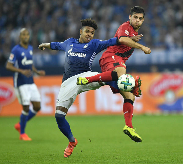 Schalke's Weston McKennie (left) and Leverkusen's Kevin Volland challenge for the ball during the German Bundesliga soccer match between FC Schalke 04 and Bayer Leverkusen at the Arena in Gelsenkirchen, Germany on Friday.