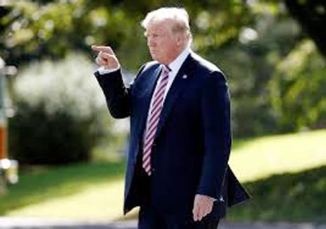 U.S. President Donald Trump points to Marine One as he departs for Bedminster, New Jersey, from the White House in Washington, U.S.