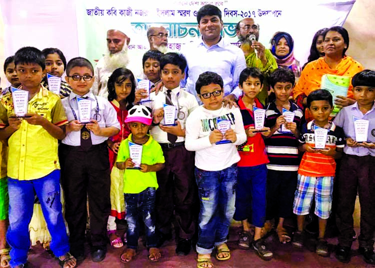 Councillor of 26 No ward of DSCC Hasibur Rahman Manik among the children at a discussion and prize giving ceremony on the occasion of World Children Day and in memory of National Poet Kazi Nazrul Islam organised by Suchana in Azimpur Samaj Kalyan auditori