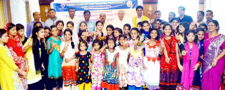 Leaders of Lions Club of Chittagong Presidency posed for a photo session after distributing of educational materials among the children in the Port City recently.