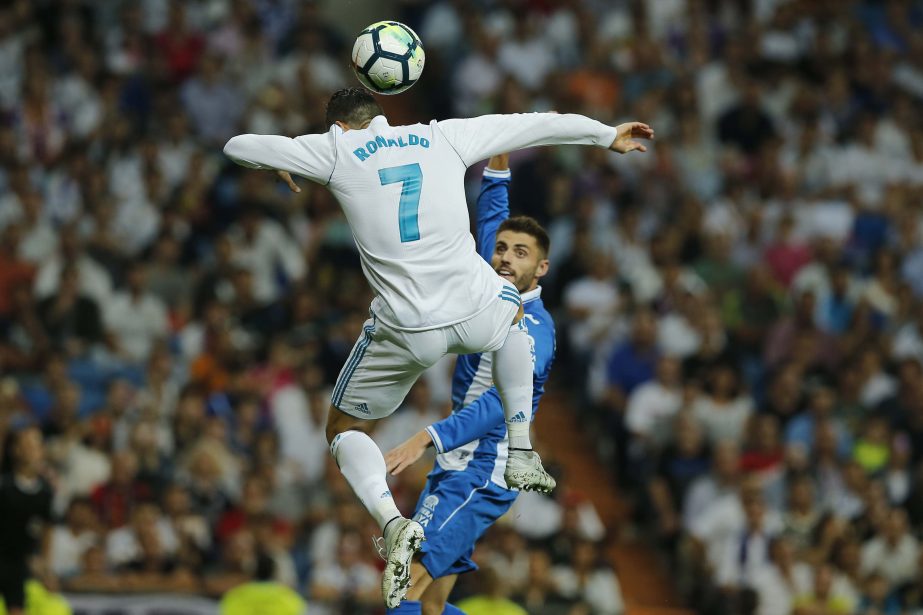 Real Madrid's Cristiano Ronaldo jumps for a high ball during a Spanish La Liga soccer match between Real Madrid and Espanyol at the Santiago Bernabeu stadium in Madrid, Spain on Sunday.