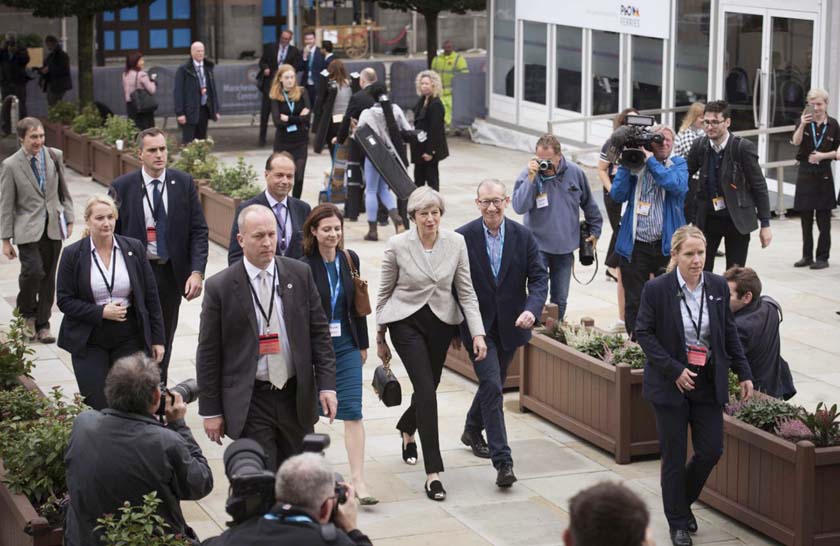 Britain's Prime Minister Theresa May, centre, and her husband Philip arrive for the Conservative Party Conference at the Manchester Central Convention Complex in Manchester, England on Sunday.