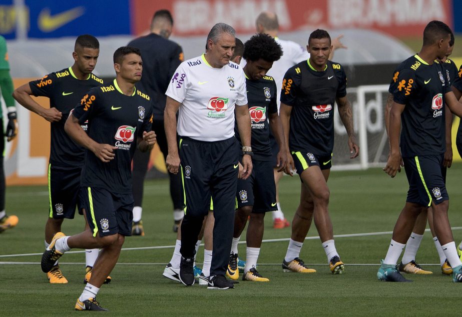 Brazil coach Tite walks on the pitch during a training session in preparation for an upcoming World Cup qualifying match in Teresopolis, Brazil on Monday.