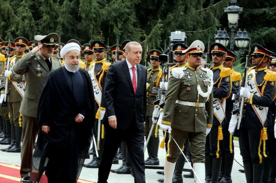 Iranian President Hassan Rouhani (L) welcomes Turkish counterpart Recep Tayyip Erdogan to Tehran on Wednesday in a sign of warming ties between the two neighbours which both strongly oppose last week's Iraqi Kurdish vote for independence
