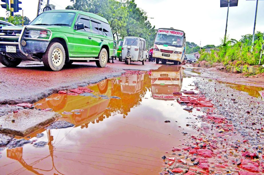 Potholes and cracks being developed at a busy road in city's Agargaon area with waterlogging despite frequent repairs causing sufferings to commuters and movement of vehicles. This photo was taken on Wednesday.