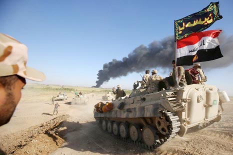 Iraqi forces and fighters from the Hashed al-Shaabi advance towards the Islamic State (IS) group's stronghold of Hawija on Wednesday.