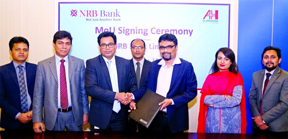 Imran Ahmed FCA, Chief Operating Officer of NRB Bank Limited and Syed Sabbir Ahmed, Executive Director of Al Haramain Hospital (Pvt.) Limited, Sylhet exchanging an agreement signing documents at the bank's head office in the city on Wednesday. Under the