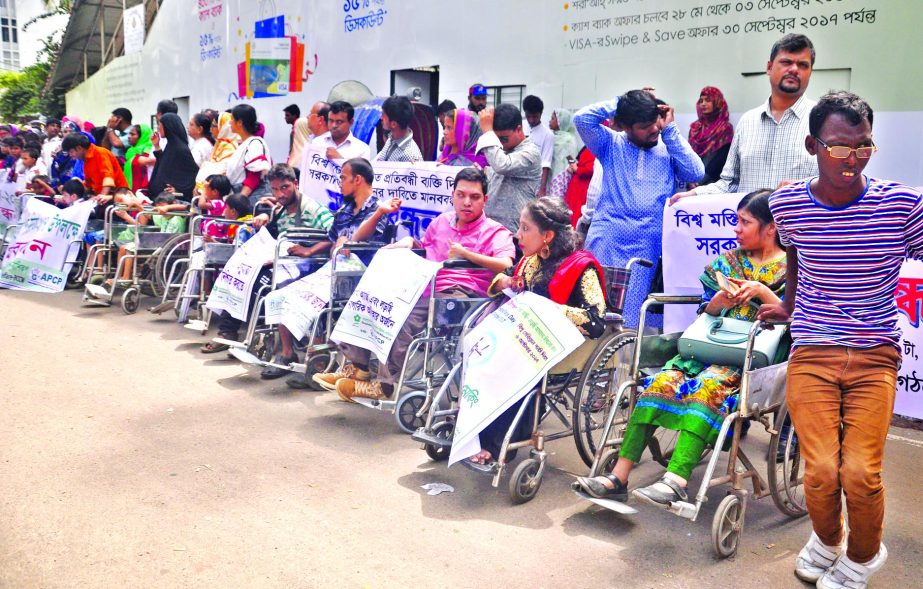 Bangladesh Shishu Kalyan Parishad formed a human chain with physically challenged persons in front of the Jatiya Press Club marking the World Cerebral Polsy Day on Thursday.