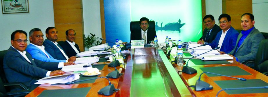 Barrister Sheikh Fazle Noor Taposh MP, EC Chairman of Modhumoti Bank Limited, presiding over 61st meeting at the bank's head office in the city on Thursday. Mohammad Ismail Hossain, Managing Director of Sharmin Group, Salahuddin Alamgir, Chairman, Labib
