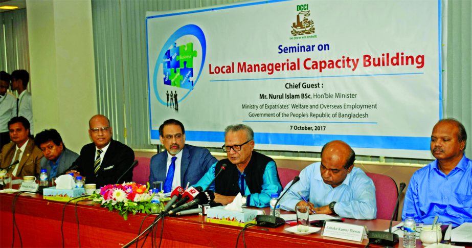 Expatriates' Welfare and Overseas Employment Minister Nurul Islam addressing a seminar on 'Local Managerial Capacity Building' at the DCCI auditorium on Saturday. DCCI President Abul Kasem Khan was in the chair.