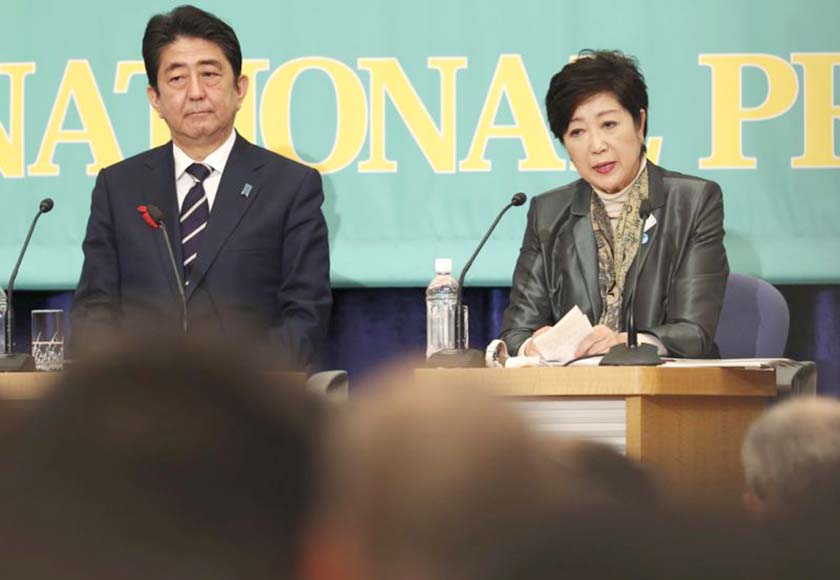 Party of Hope leader Yuriko Koike, (right), speaks as Ruling Liberal Democratic Party leader and Japan's Prime Minister Shinzo Abe listens during the party leaders' debate for the Oct. 22 lower house election in Tokyo on Sunday