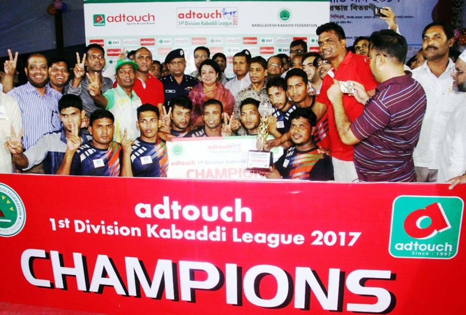 Members of Sunshine Sporting Club, the champions of the Adtouch First Division Kabaddi League and the guests and officials of Bangladesh Kabaddi Federation pose for photograph at Kabaddi Stadium on Sunday.
