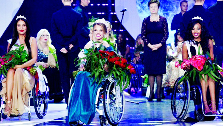 Miss Wheelchair World 2017 winner Aleksandra Chichikova, center, from Belarus, with second placed Lebohang Monyatsi, right, from South Africa and third placed Adrianna Zawadzinska, left, from Poland during the Miss Wheelchair World 2017 beauty pageant fin