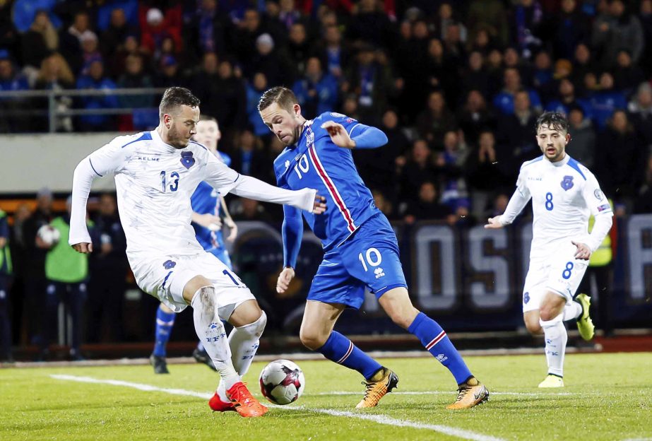 Iceland's Ragnar Ragnusson (right) challenges Kosovo's Dragan Petric for the ball during the World Cup Group I qualifying soccer match between Iceland and Kosovo in Reykjavik, Iceland on Monday.