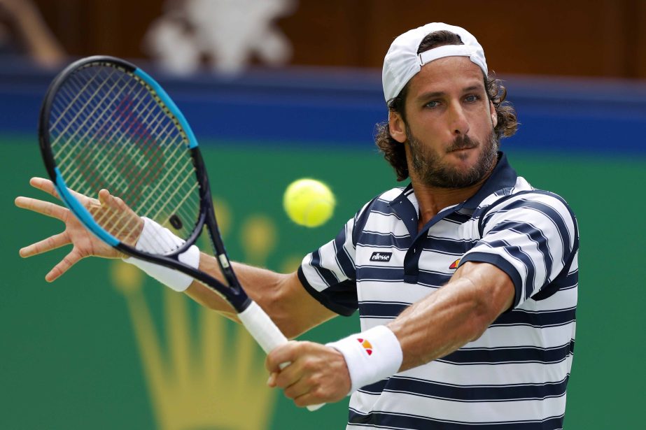 Feliciano Lopez of Spain returns a shot against Ivo Karlovic of Croatia during their men's singles match of the Shanghai Masters tennis tournament at Qizhong Forest Sports City Tennis Center in Shanghai, China on Monday