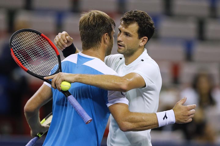 Grigor Dimitrov of Bulgaria (right) hugs his opponent Ryan Harrison of the United States after winning their men's singles match of the Shanghai Masters tennis tournament at Qizhong Forest Sports City Tennis Center in Shanghai, China on Wednesday.