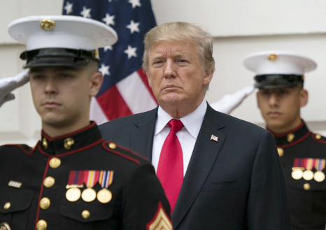 President Donald Trump stands behind and in front of members of a Marine honor guard as he greets Canadian Prime Minister Justin Trudeau and Sophie Gregoire Trudeau as they arrive at the White House in Washington on Wednesday.