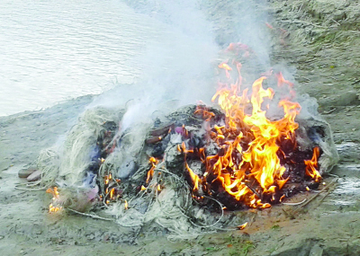 MADHUKHALI (Faridpur): Mobile Court burning two thousand meter nets at Sitarampur area for catching mother hilsa on Tuesday.