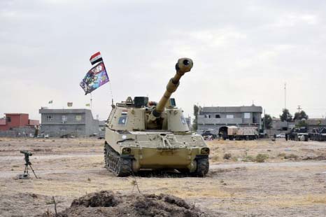 Iraqi tanks deploy in the village of Bashir, south of Kirkuk, Iraq on Friday.