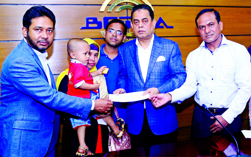 Md. Siddiqur Rahman, President of BGMEA, handing over cheques of group insurance to the nominees of 31 workers and employees of ready-made garment factories who died during their service at its office in the city on Sunday. SM Mannan (Kochi) and Mohammed