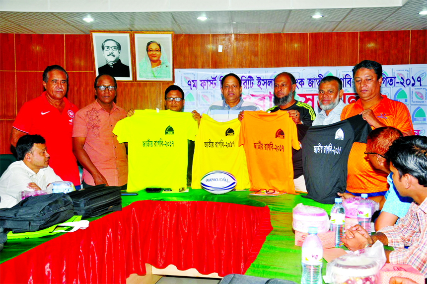 The officials of Bangladesh Rugby Federation showing jerseys of 7th First Security Islami Bank National Rugby Competition at the conference room of the Bangabandhu National Stadium on Sunday.