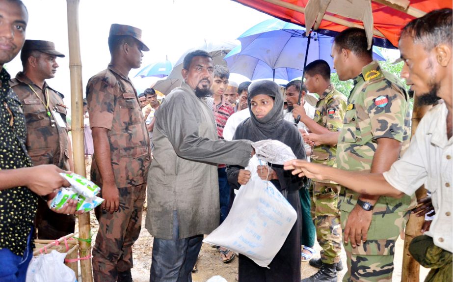 Mir Mohammad Abu Hanif, Vice - President, Bangladesh Shadhinota Parishad distributing relief goods among the Rohingya people at Ukhiya Upazila recently.