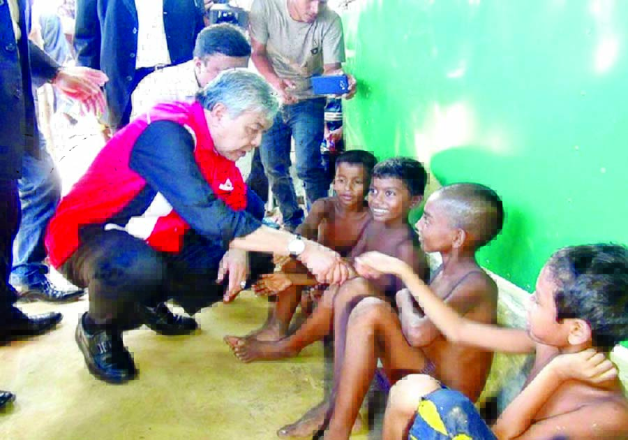 Malaysian Deputy Prime Minister Dr. Ahmed Zahid Hamidi talking to fleeing Rohingya children while visiting Kutupalong refugee camps in Ukhiya of Cox's Bazar on Monday.