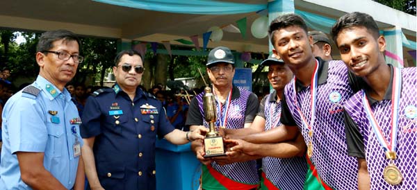 Air Officer Commanding of BAF Base Bashar Air Vice Marshal Ehsanul Gani Choudhury giving away trophy to BAF Shaheen College Dhaka team who won the Inter Shaheen Hockey title at Shaheen College Hockey turf, Dhaka on Wednesday.