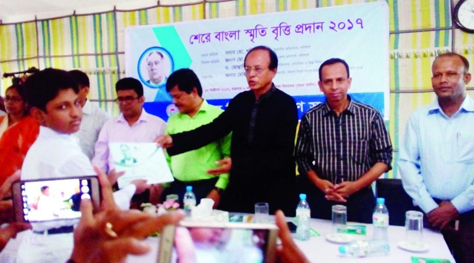 BARISAL: Mohammad Ismail, Chairman, Board of Directors of Bangladesh Krishi Bank distributing Sher-e- Bangla Smriti Scholarship among the students at Girls' School Auditorium in Barisal Sadar Upazila organised by Barisal Division Kalyan Samity rece