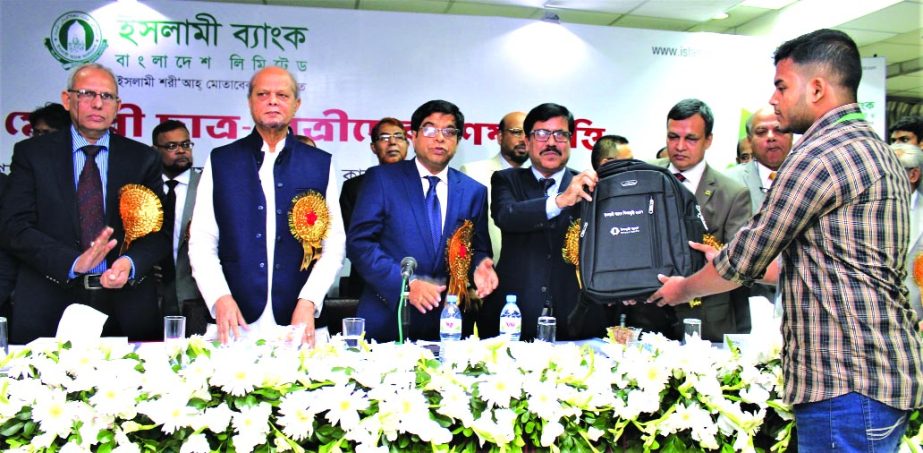 SM Moniruzzaman, Deputy Governor of Bangladesh Bank, handing over the scholarship money and gift items as chief guest at IDEB auditorium in the city on Friday arranged by the Islami Bank Bangladesh Limited. Arastoo Khan, Chairman, Md Abdul Hamid Miah, Man