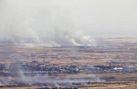 Smoke billows from the Syrian side of the armistice line on the Golan Heights after fire into the Israeli-occupied sector sparked retaliation by the army.