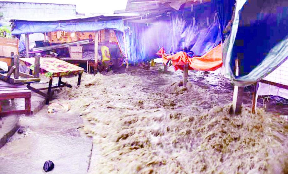 Tidal waters entered the houses and shops eroding the embankment at sea beach area of Patenga in Chittagong due to depression in Bay since Thursday. This photo was taken on Saturday.