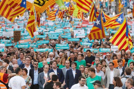 Catalan leaders including regional president Carles Puigdemont join a rally in Barcelona in support of separatists.