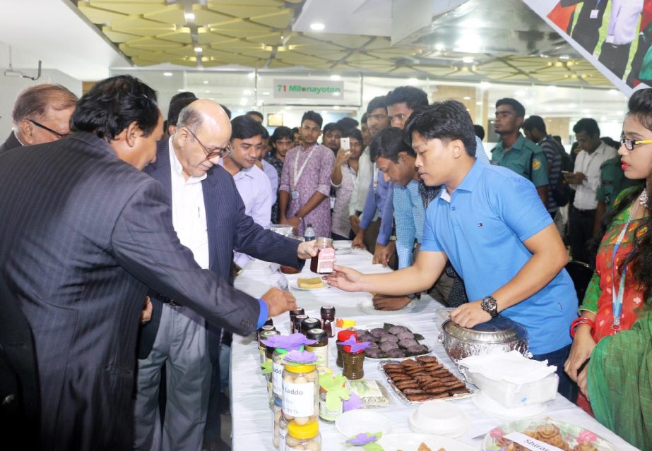 Food Minister Advocate Md. Qamrul Islam, MP, visiting stalls set up by the students of Nutrition and Food Engineering Department of Daffodil International University after a seminar on 'Change the future of migration: invest in food security and rural de