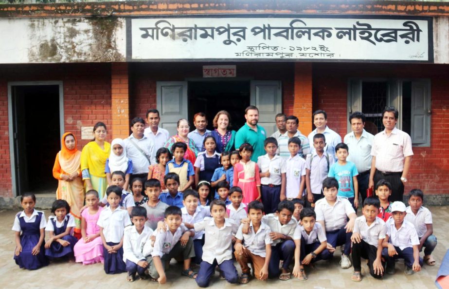 Senior officials of USAID pose for a photo-shoot with students of a primary school in Monirampur, Jessore on Wednesday.