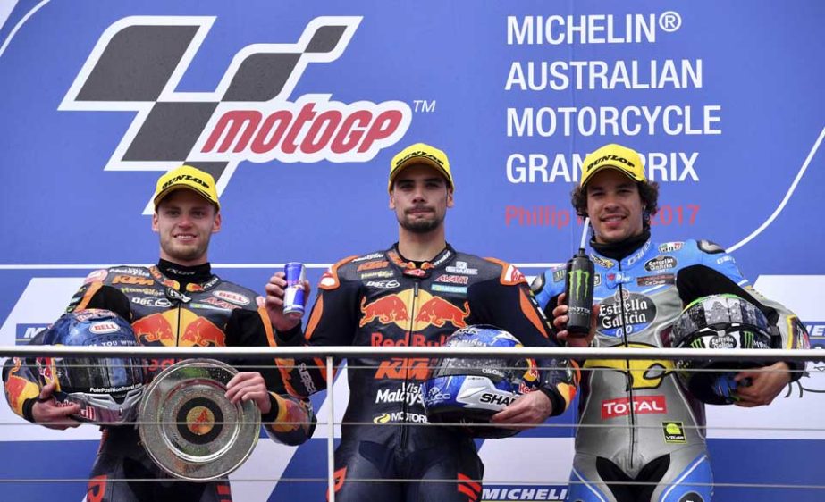 aMoto2 race winner Portugal's Miguel Oliveira (center) celebrates on the podium with second placed teammate Brad Binder (left) and third placed Italy's Franco Morbidelli at the Australian Motorcycle Grand Prix at Phillip Island near Melbourne, Australia