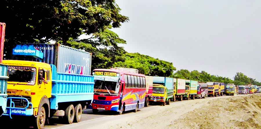 Several vehicles got stuck at long tailback created at several points on Dhaka-Tangail Highway from Chandra to Elenga in the district due to sorry state of the road, triggered by heavy downpour for a couple of days. This photo was taken from Elenga on Sun