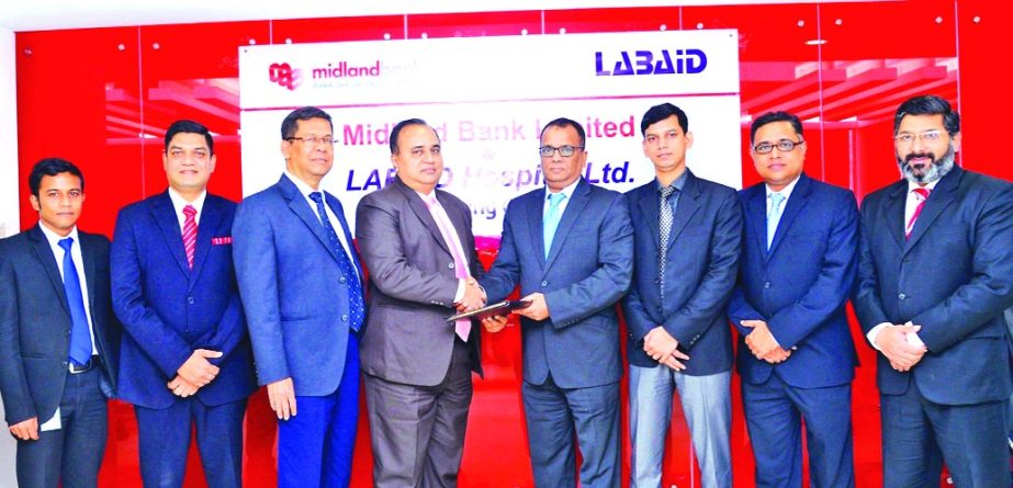 Masihul Huq Chowdhury, AMD of Midland Bank Limited and Al Emran Chowdhury, Chief Operating Officer of Labaid Hospitals, exchanging an MoU signing documents at the bank's head office in the city on ed the on behalf of their respective organizations at a s