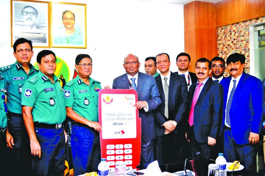 AE Abdul Muhaimen, Managing Director of United Commercial Bank Limited handing over 500 POS machines to DMP Commissioner Md. Asaduzzaman Mia for DMP traffic division at its office in the city on Thursday. Senior officials from both the organizations were