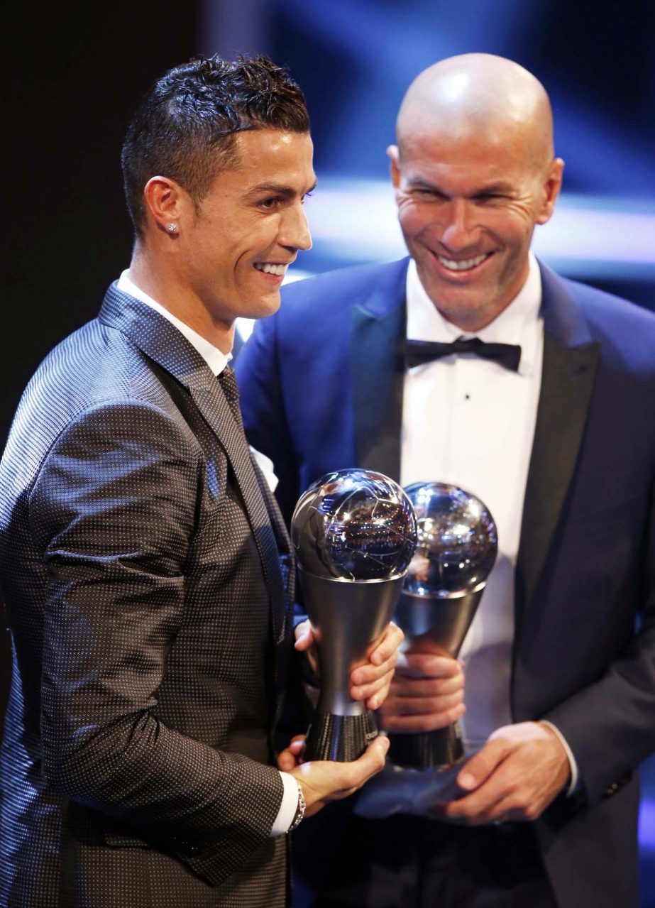 Portuguese soccer player Christiano Ronaldo holds the Best FIFA Men's Player award and Soccer coach Zinedine Zidane holds the Best FIFA Men's Coach award during The Best FIFA 2017 Awards at the Palladium Theatre in London on Monday.