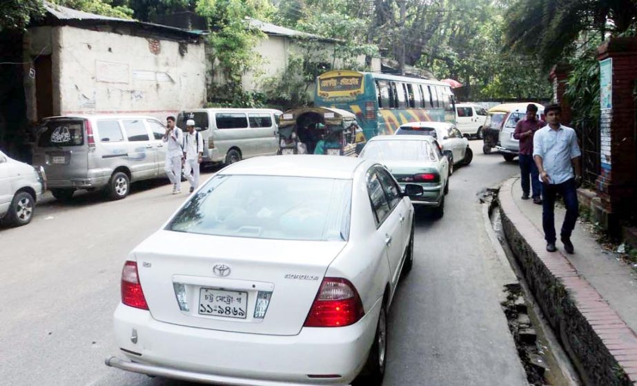 Illegal car parking at Anderkillah area made traffic jam causing sufferings to the people . This snap was taken on Monday.