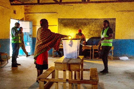 A member of the Maasai tribe casts her ballot at Kajiado Primary School in a town 80km (50 miles) south of Nairobi as Kenya votes in a presidential re-run which is being boycotted by the opposition.