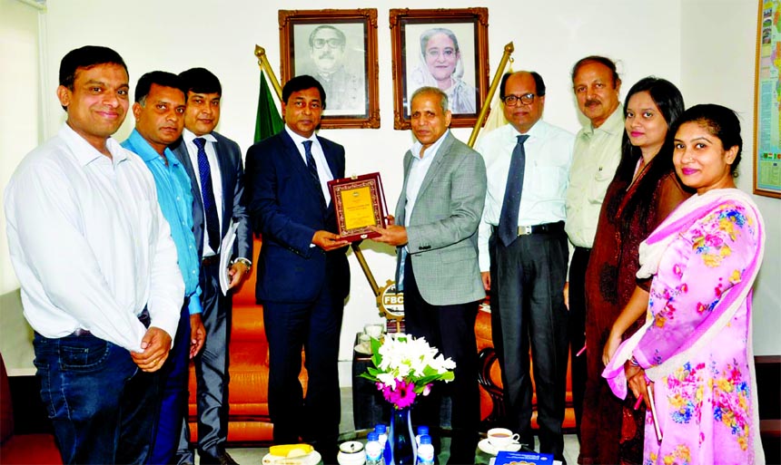 FBCCI President Md. Shafiul Islam (Mohiuddin) handing over a crest to BIMSTEC Secretary General M. Shahidul Islam at FBCCI head quarters in the city on Wednesday.