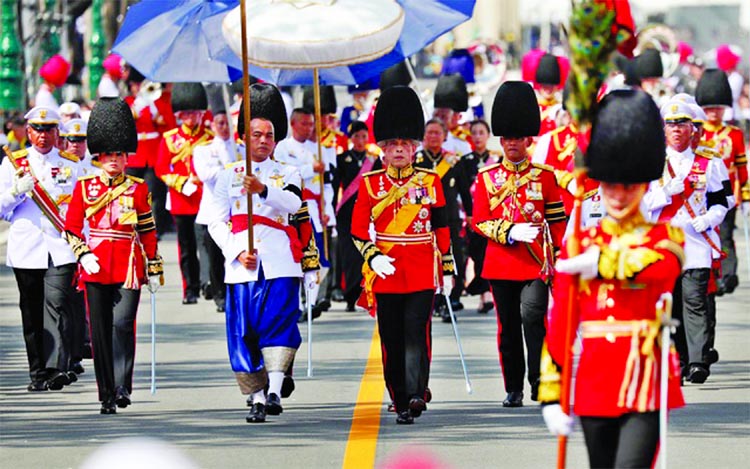 Thailand's King Maha Vajiralongkorn marches during the royal cremation procession of King Bhumibol Adulyadej at the Grand Palace in Bangkok, Thailand on Thursday.