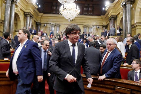 Catalan president Carles Puigdemont (center) opted not to call elections for a new regional parliament - thought to be the only way to stave off Madrid's imminent power grab