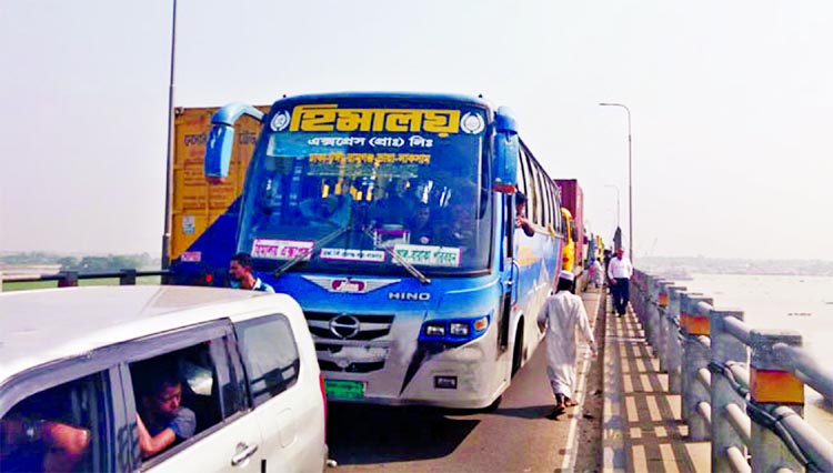 Hundreds of passengers on Friday faced untold sufferings due to long tailback stretching from Meghna-Gumti second bridge to Feni due to maintenance work of the bridge. This photo shows that several passenger vehicles, including buses, were stranded on the