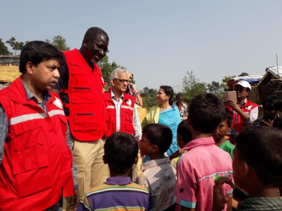 Hafiz Ahmed Mazumder, Chairman, Bangladesh Red Crescent Society and EL Hadij Amadou Gueye, Dy, Secretary General of International Federation of Red Cross and Red Crescent Societies(IFRC) talking to Rohingya children during a visit at Tambru Border in