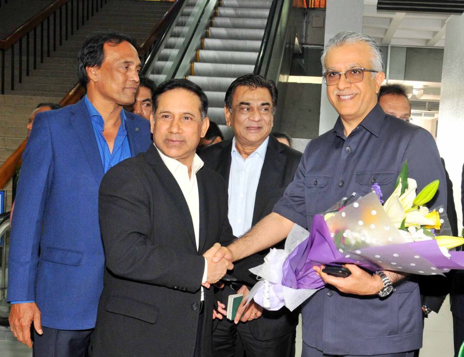 Senior Vice-President of Bangladesh Football Federation (BFF) Abdus Salam Murshedy (2nd from left) shaking hands with President of AFC Sheikh Salman Bin Ibrahim Al Khalifa (right) after receiving with bouquet at the Hazrat Shahjalal International Airport